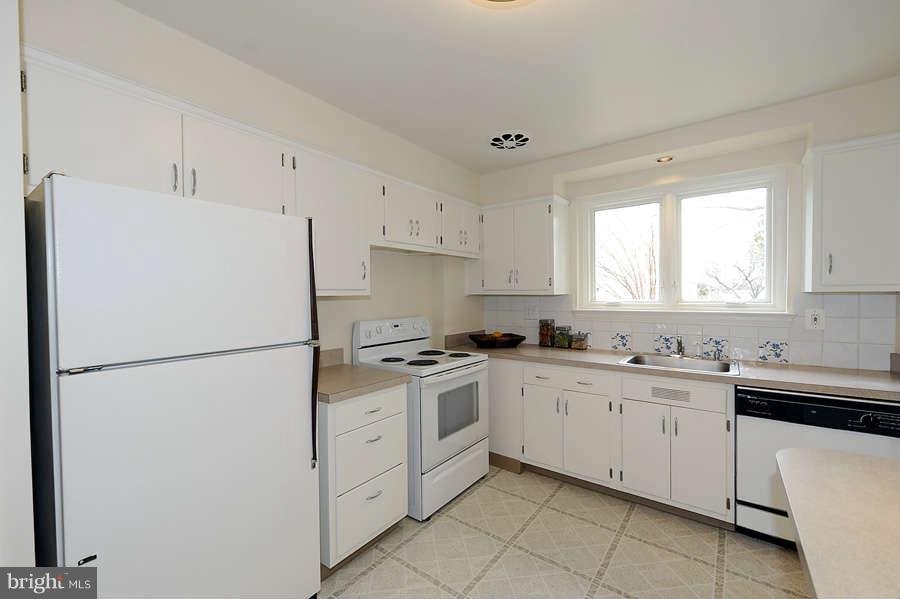 5719 Ogden Road Bethesda, MD 20816 - Photo 10 of 22 a kitchen with white cabinets and white appliances