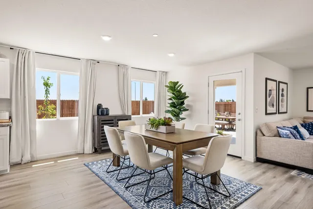 a view of a dining room with furniture and window