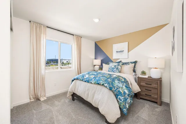 a bedroom with a bed and a window