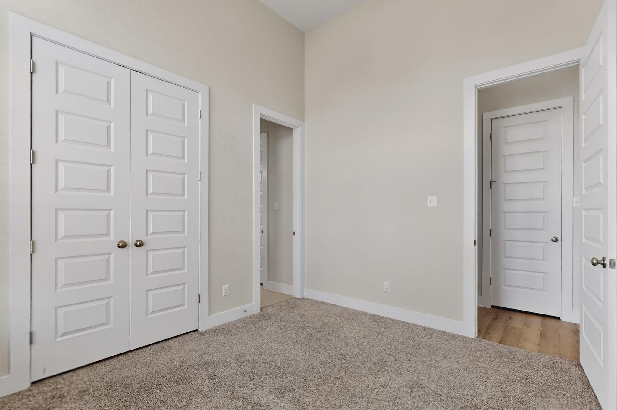 20912 Carries Ranch Road Pflugerville, TX 78660 - Photo 5 of 20 High ceilings and clean panel doors highlight this versatile space featuring neutral carpeting.