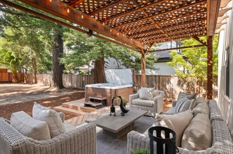 a view of patio with couches table and chairs and potted plants
