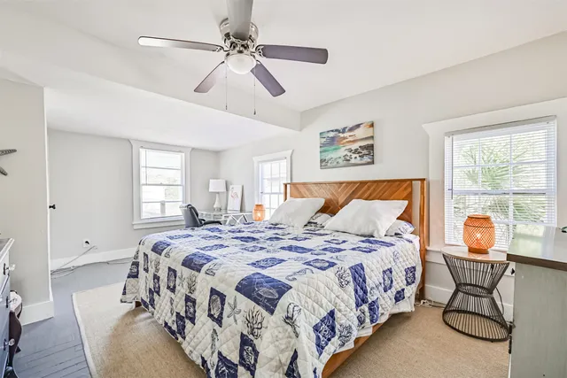 a bedroom with a large bed and a window