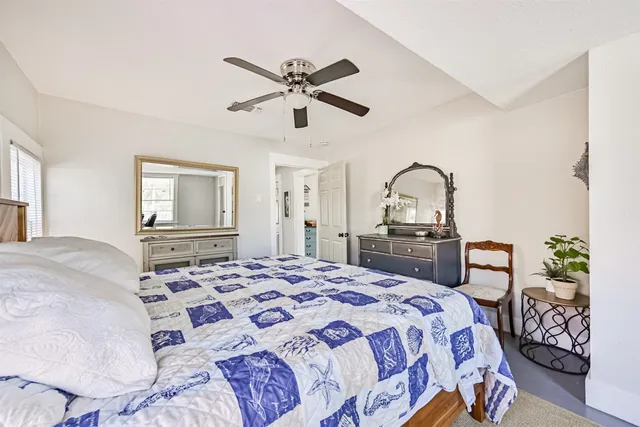 a bedroom with a bed and a dresser