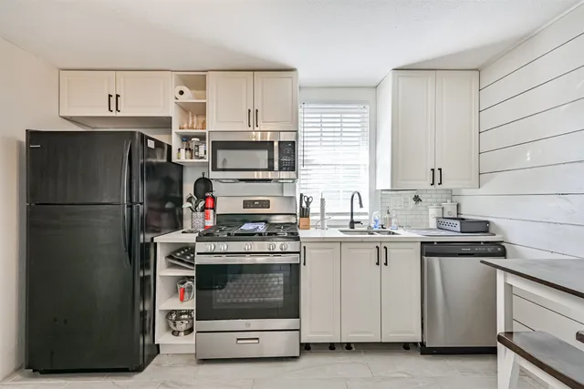 a kitchen with a stove and a refrigerator
