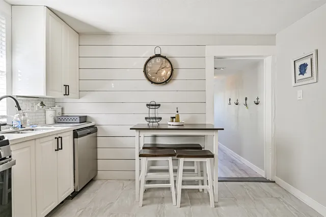 a kitchen with a sink cabinets and stainless steel appliances