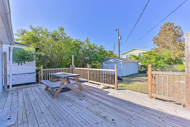 a view of balcony with wooden floor and outdoor seating