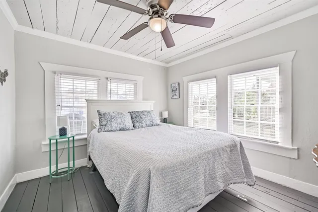 a bedroom with a large bed and a window