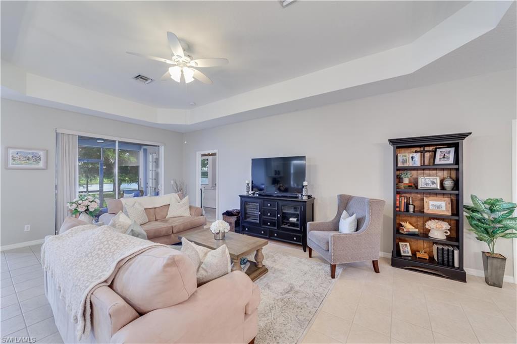20599 Ardore Lane Estero, FL 33928 - Photo 13 of 34 a living room with furniture and a flat screen tv