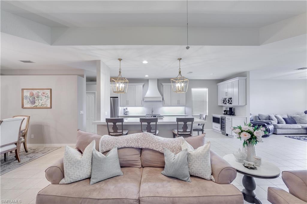 20599 Ardore Lane Estero, FL 33928 - Photo 15 of 34 a living room with furniture and a chandelier