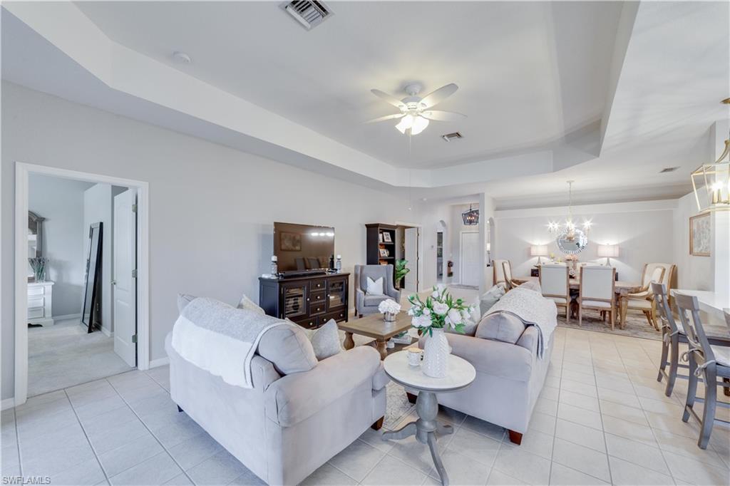 20599 Ardore Lane Estero, FL 33928 - Photo 16 of 34 a living room with furniture a table and a flat screen tv