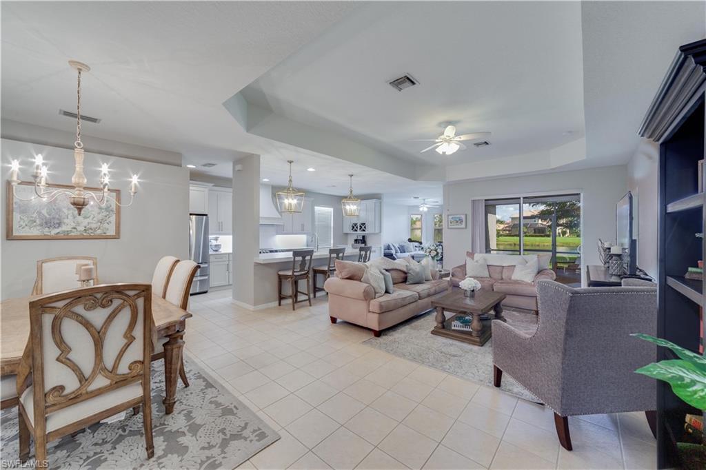 20599 Ardore Lane Estero, FL 33928 - Photo 17 of 34 a living room with furniture kitchen view and a chandelier