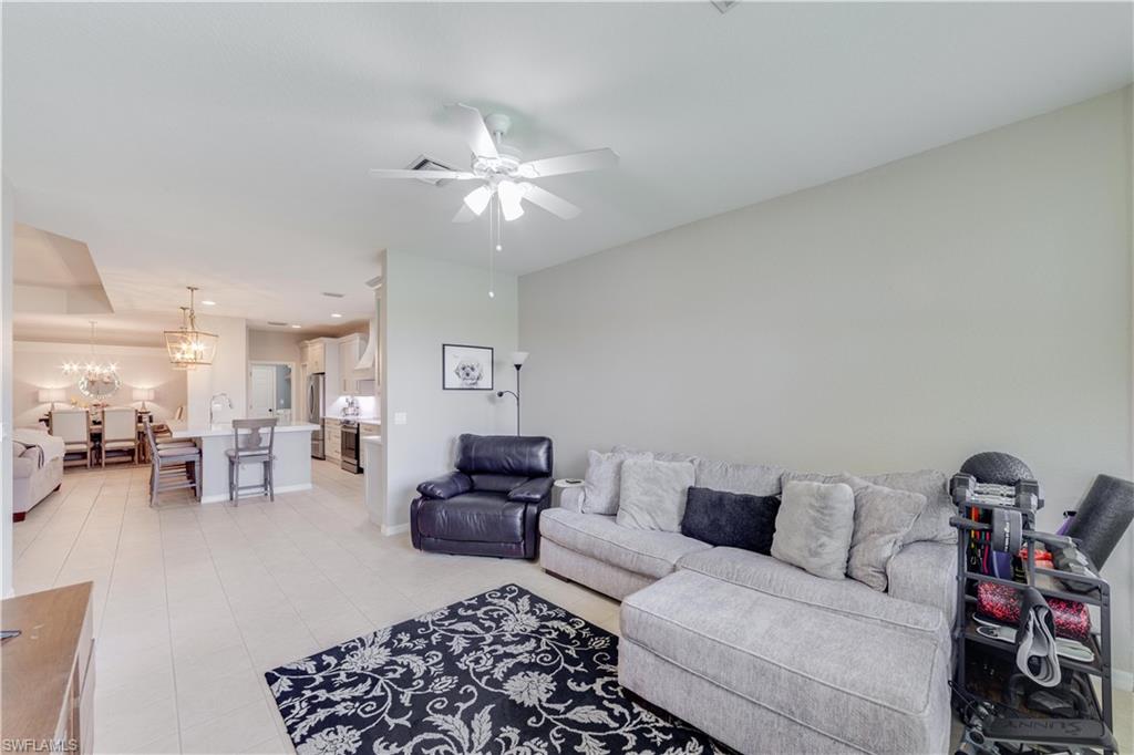 20599 Ardore Lane Estero, FL 33928 - Photo 19 of 34 a living room with furniture and a chandelier