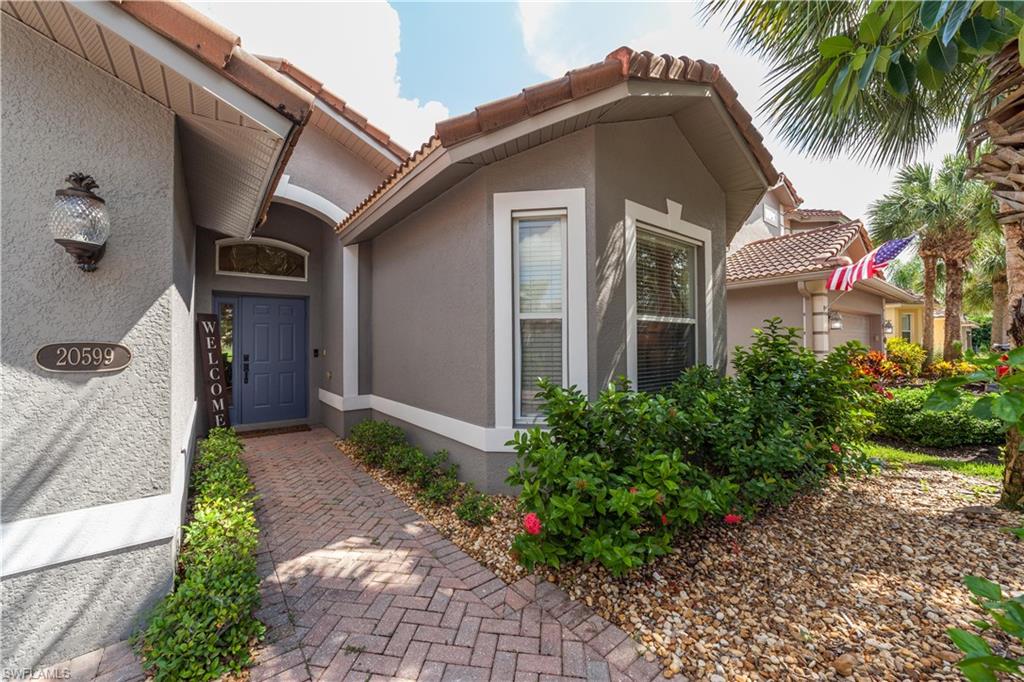 20599 Ardore Lane Estero, FL 33928 - Photo 2 of 34 a front view of a house with a yard