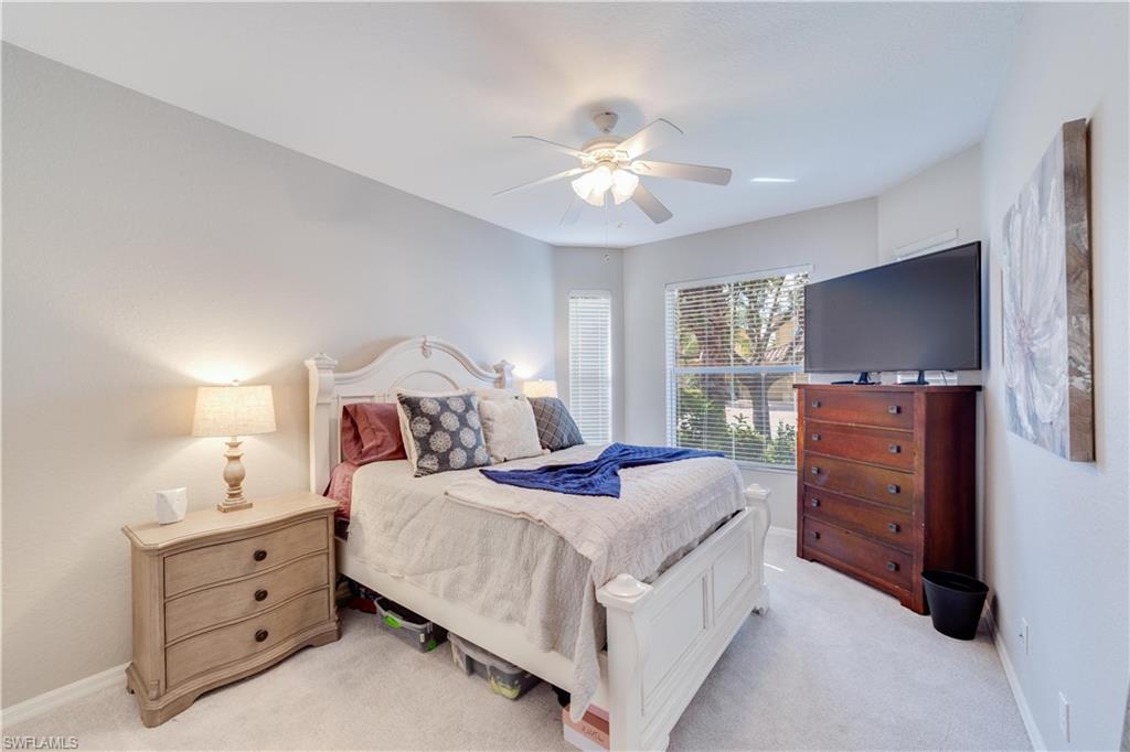 20599 Ardore Lane Estero, FL 33928 - Photo 26 of 34 a bedroom with a bed and a dresser