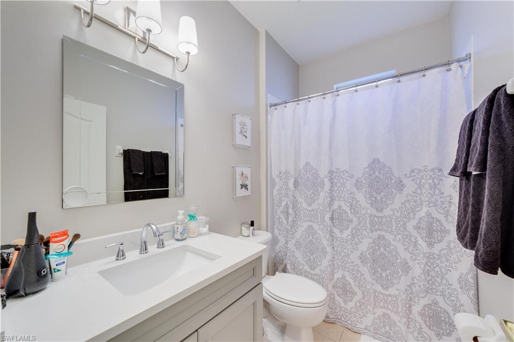 20599 Ardore Lane Estero, FL 33928 - Photo 27 of 34 a bathroom with a sink toilet and shower