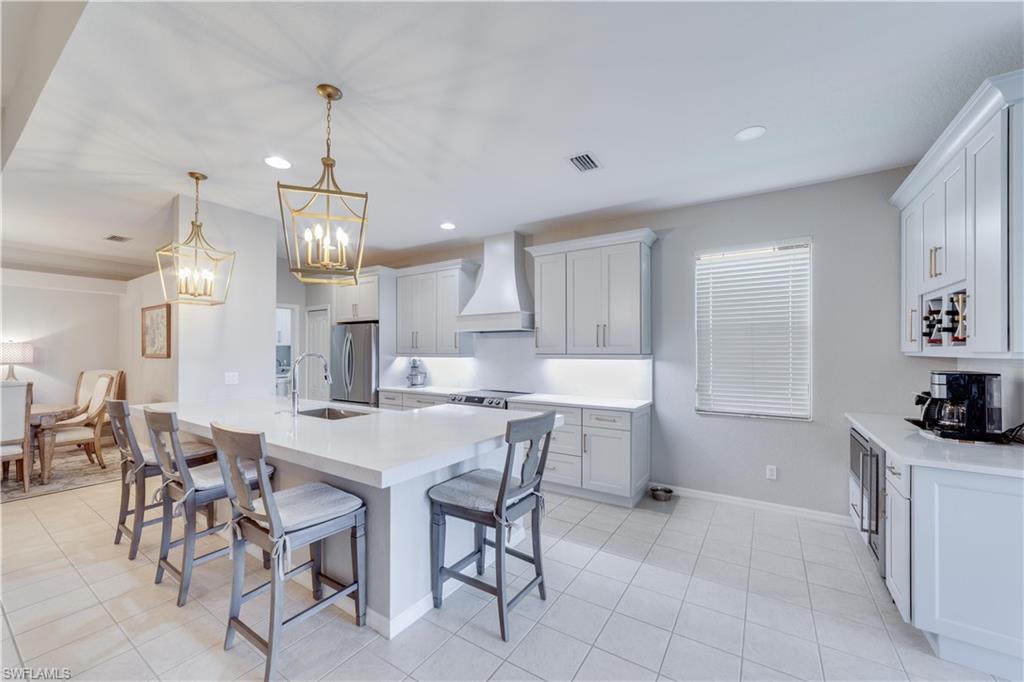 20599 Ardore Lane Estero, FL 33928 - Photo 3 of 34 a large kitchen with a table and chairs