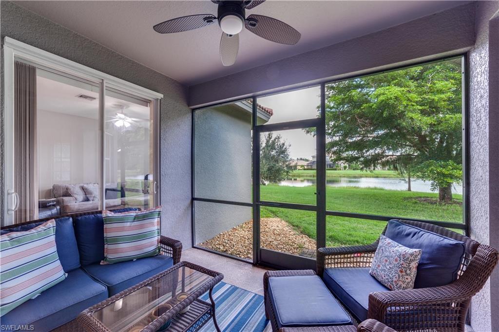 20599 Ardore Lane Estero, FL 33928 - Photo 31 of 34 a living room with large windows and wooden floor