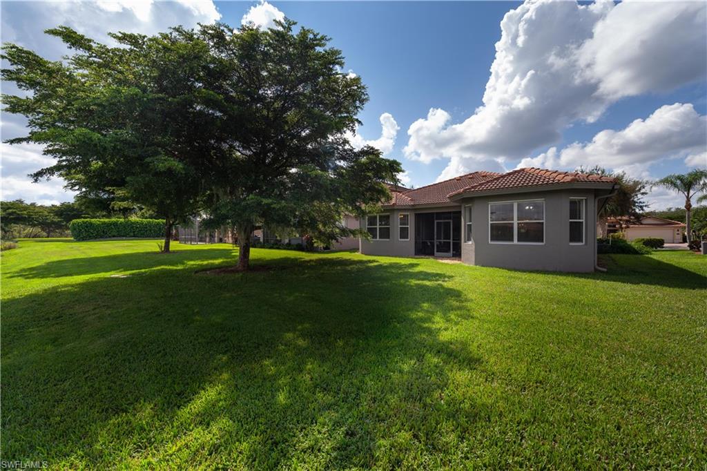 20599 Ardore Lane Estero, FL 33928 - Photo 33 of 34 a view of a house with a backyard