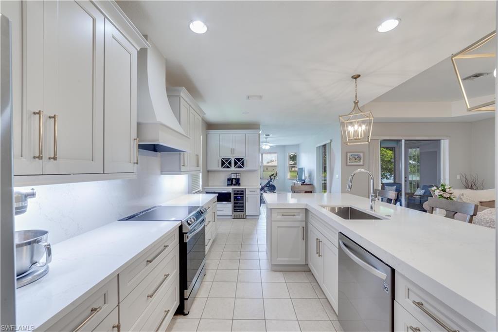 20599 Ardore Lane Estero, FL 33928 - Photo 4 of 34 a kitchen with a sink stove and cabinets