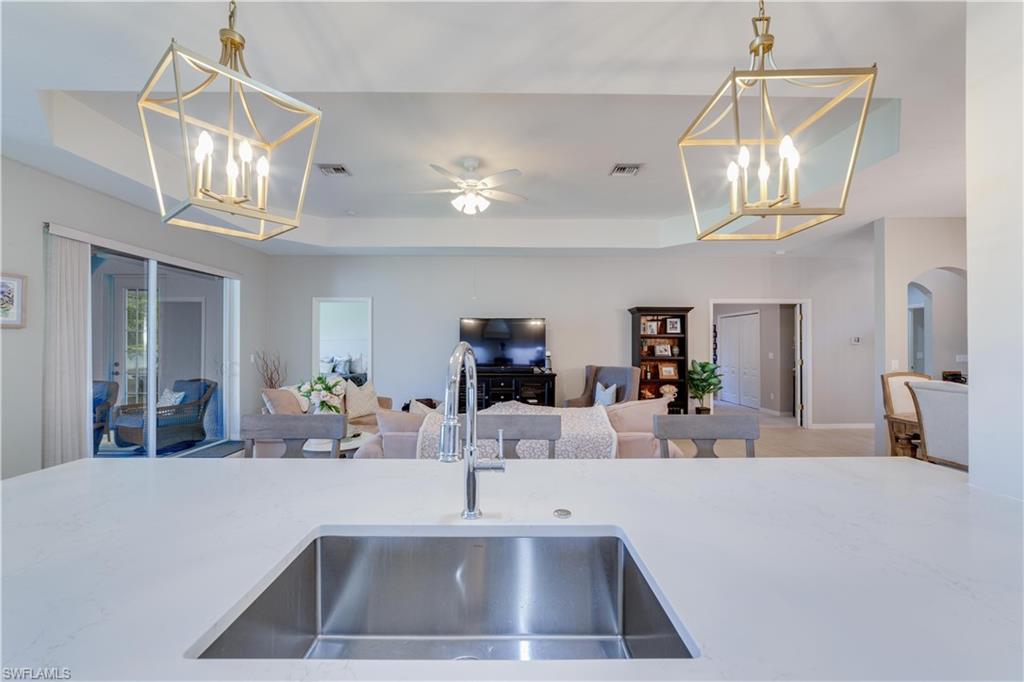 20599 Ardore Lane Estero, FL 33928 - Photo 9 of 34 a view of a room with shelves and chandelier