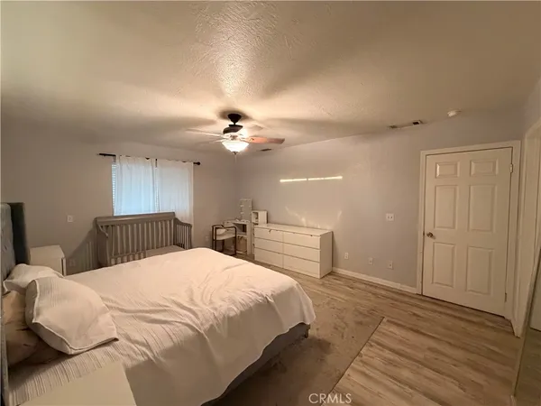 an empty room with a ceiling fan and carpet