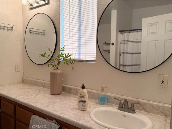a view of a bathroom with a sink and a mirror