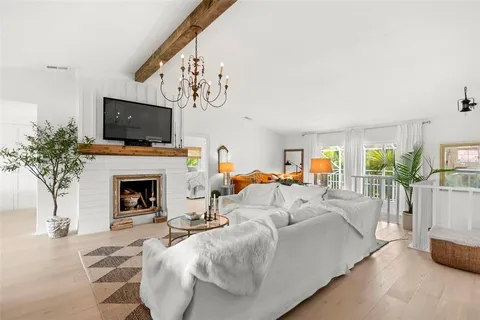 a bedroom with furniture and a wooden floor