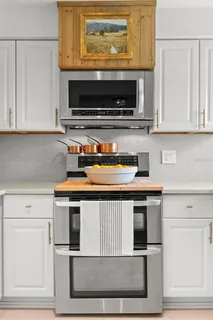 a spacious bedroom with a bed and a chandelier