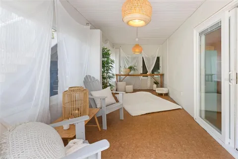 a view of a house with a yard and sitting area