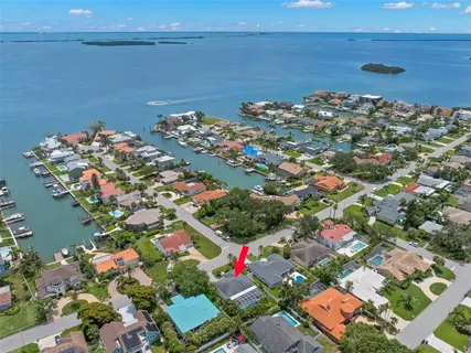 a dining room with furniture a chandelier and wooden floor