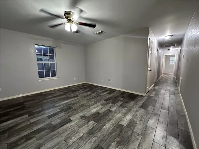 a view of a livingroom with a ceiling fan and window