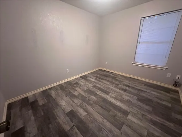 a view of room with window and hardwood floor