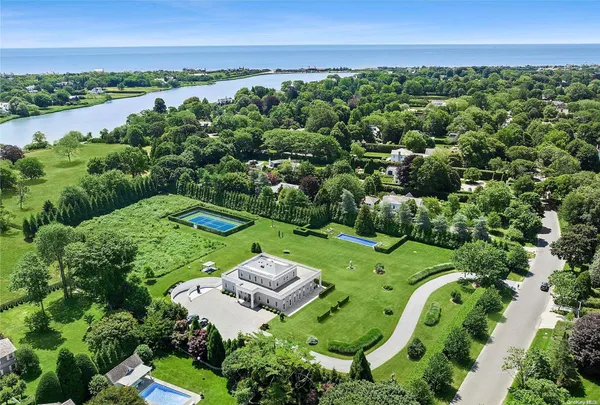 an aerial view of a house with a yard and lake view