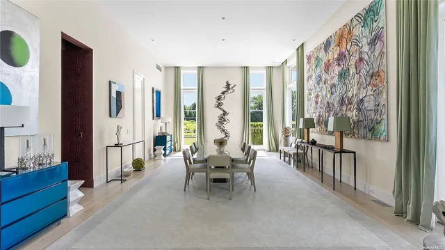 a living room with furniture and large windows