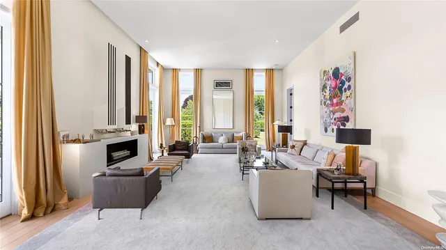 a living room with furniture and large windows