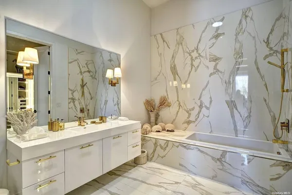 a spacious bedroom with a bed and a chandelier