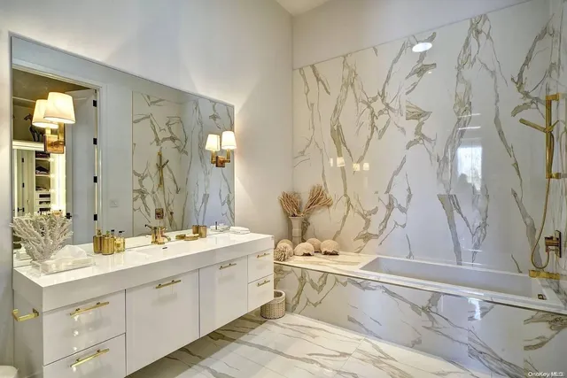 a spacious bedroom with a bed and a chandelier