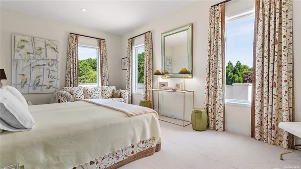 a bathroom with a double vanity sink and mirror with shower
