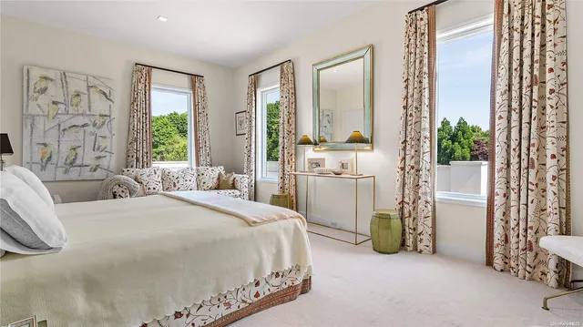 a bathroom with a double vanity sink and mirror with shower