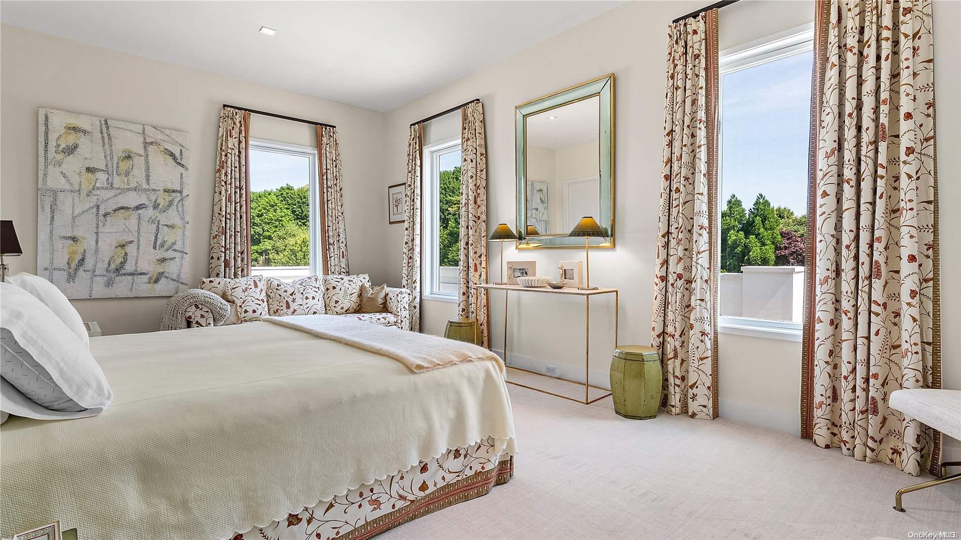 Undisclosed Address Southampton, NY 11968 - Photo 10 of 12 a spacious bedroom with a bed and a chandelier