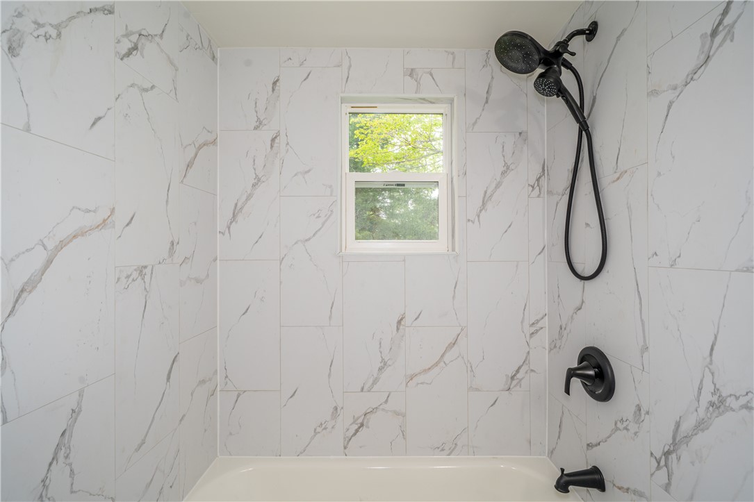 11296 Pansing Road Brookville, OH 45309 - Photo 23 of 53 This bathing space features classic white tile and modern fixtures for a refreshing start to your day.