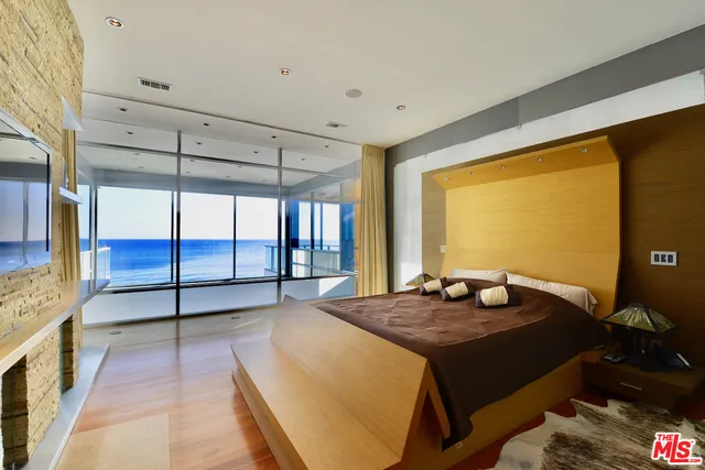 a living room with a bed furniture and next to a window