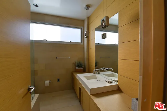 a room with pool table and glass windows