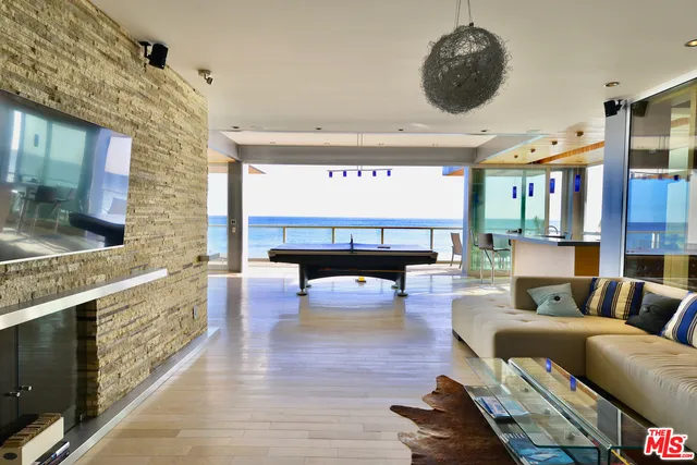 a living room with furniture and a kitchen view