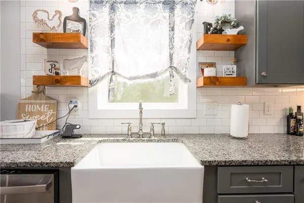 a kitchen with stainless steel appliances granite countertop wooden cabinets a sink and dishwasher