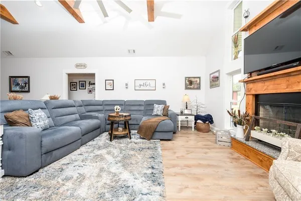 a living room with lots of furniture and kitchen view