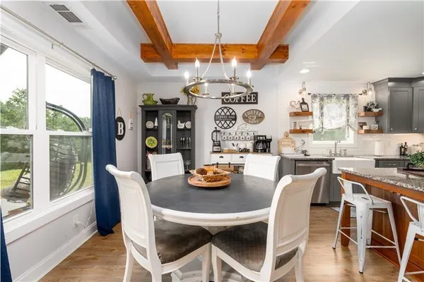 a kitchen with granite countertop a sink a stove and a wooden cabinets