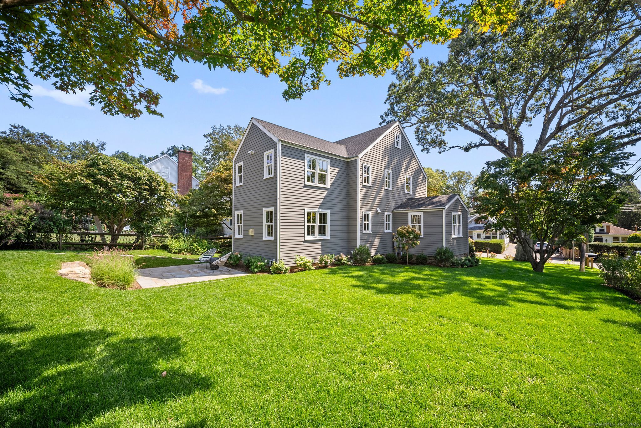 7 Wild Rose Road Westport, CT 06880 - Photo 27 of 33 a view of a house with a big yard and large trees