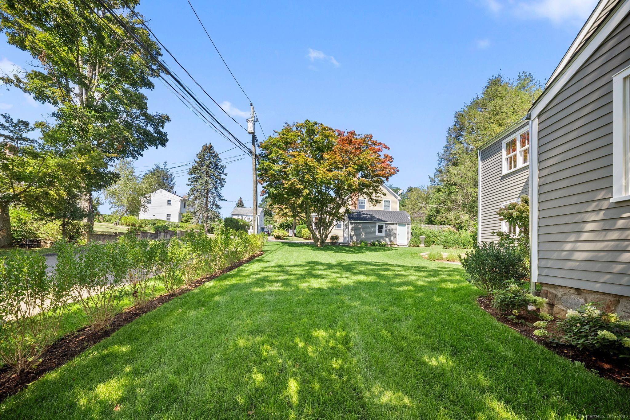 7 Wild Rose Road Westport, CT 06880 - Photo 30 of 33 a backyard of a house with lots of green space