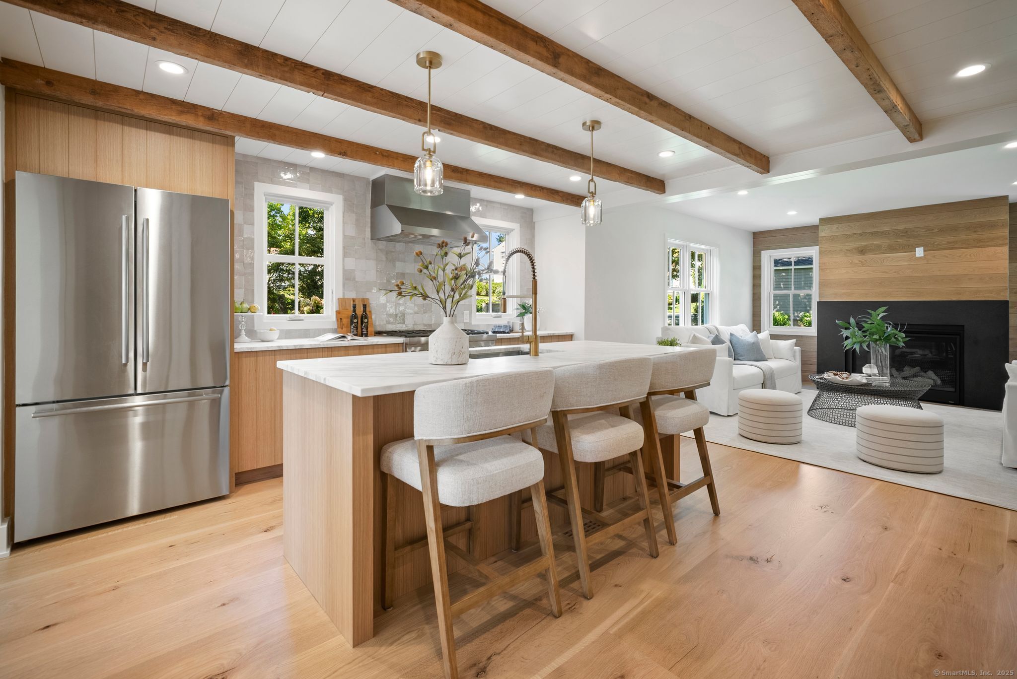 7 Wild Rose Road Westport, CT 06880 - Photo 7 of 33 a kitchen with a dining table chairs refrigerator and cabinets